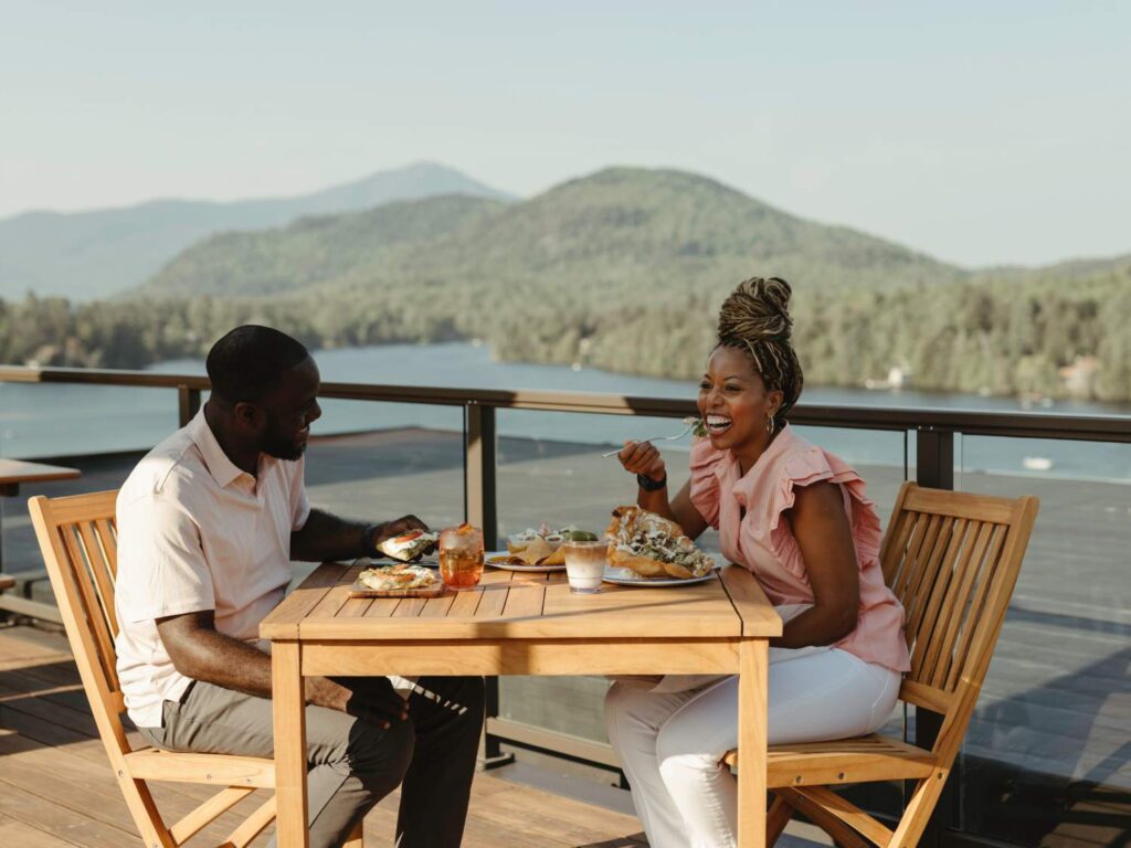 a man and a woman sitting at a table eating food